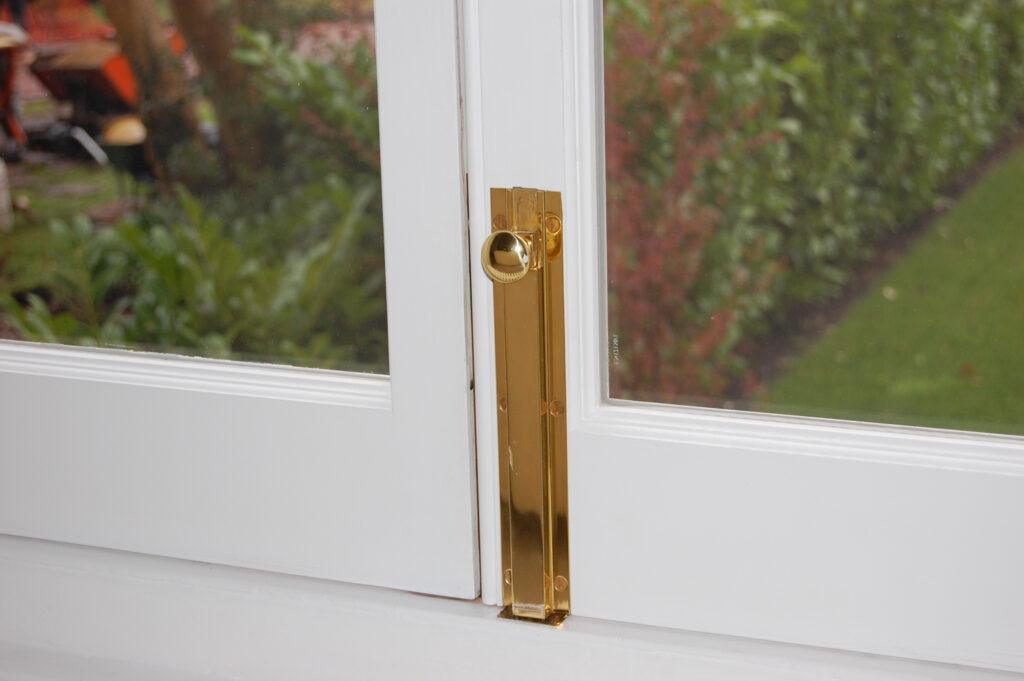Brass flush bolt on French door system