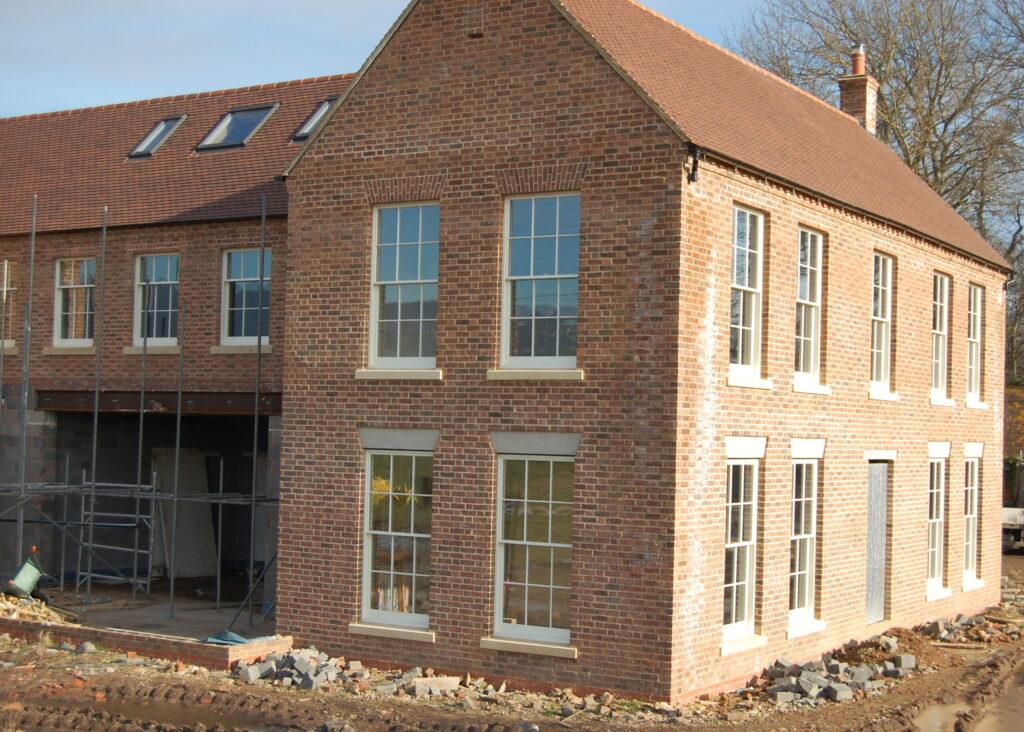 Final stages of new buid Herefordshire farmhouse featuring large six over six Georgian style box sash windows