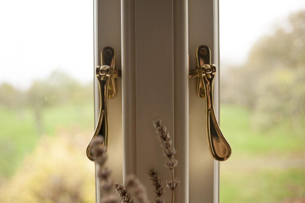 Brass fasteners on a casement window